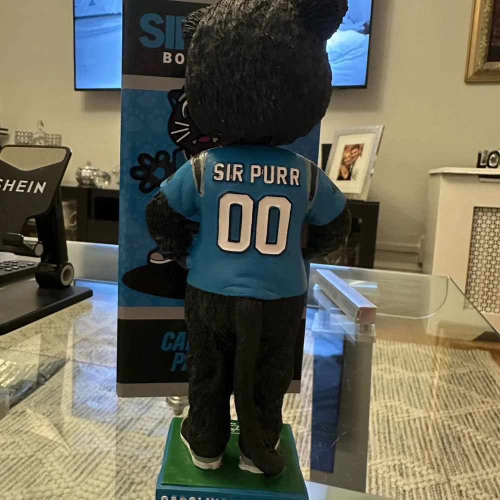 The item in the image is a Sir Purr Carolina Panthers mascot figurine/statue.
